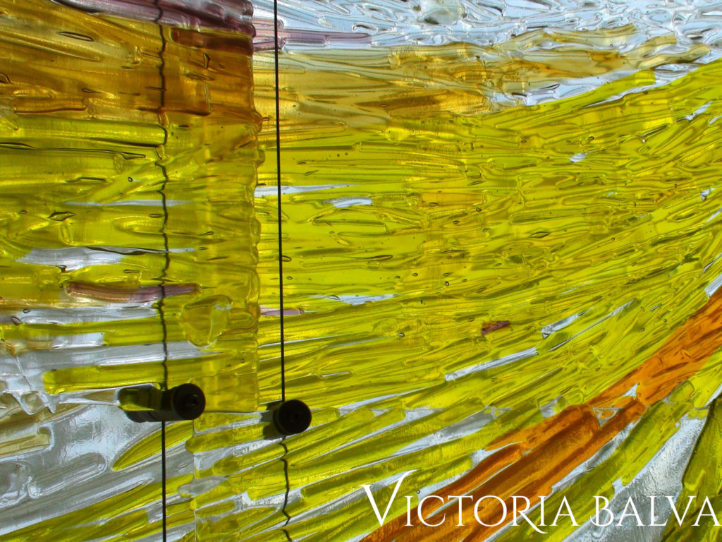 Bright yellow and clear fused art glass suspended sculpture texture at Mississauga catholic school