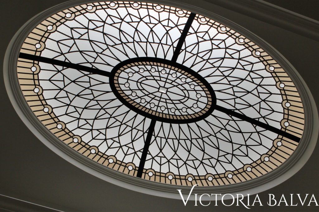 Stained and leaded glass oval dome lay light with bronze glass border ans clear accent jewels