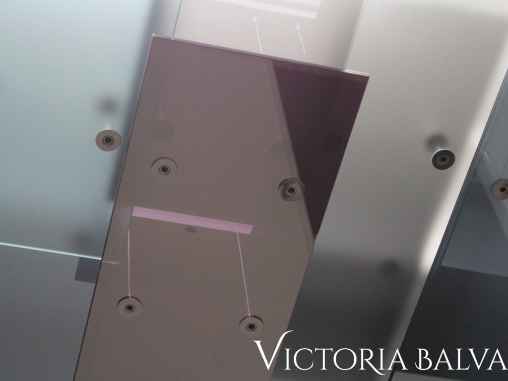 Decorative laminated reflective glass of different colours on stainless steel hardware