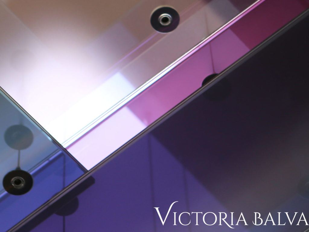 Decorative laminated coloured reflective glass suspended detail