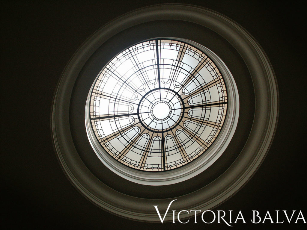 Decorative stained and leaded glass skylight ceiling for a circular staircase hallway
