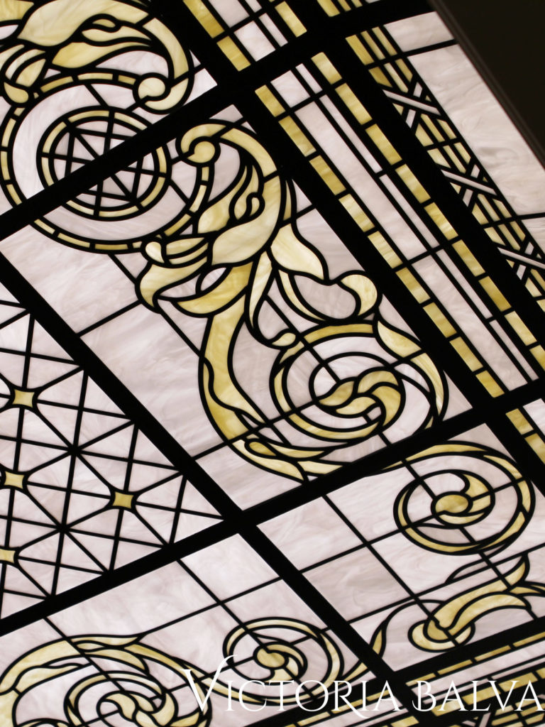 Stained glass skylight with intricate line work and white opal glass