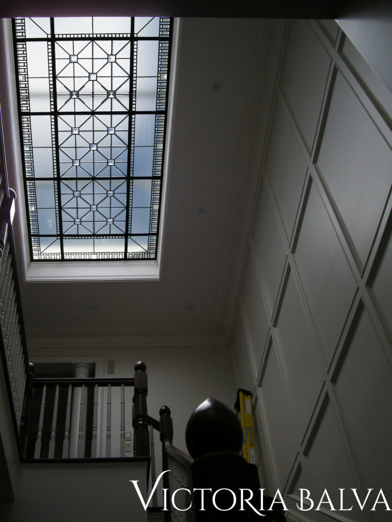 Interior design with leaded glass decorative ceiling above the staircase of a custom-built residence in Toronto